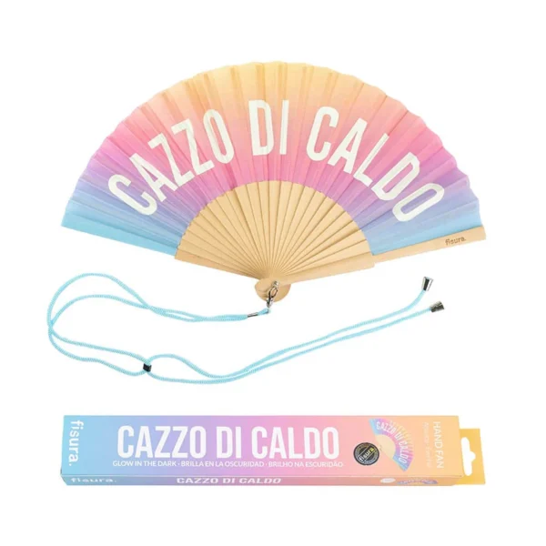 Ventaglio pieghevole con un gradiente di colori pastello che sfumano dal giallo, all'arancione, al rosa, al viola e all'azzurro. Le stecche sono in legno chiaro. Sul tessuto è stampata in bianco la frase 'CAZZO DI CALDO'. Sotto il ventaglio è posizionato un cordino azzurro, e accanto ad esso la scatola di imballaggio coordinata che ripete la frase e indica 'GLOW IN THE DARK'."