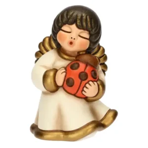 Angelo Thun in ceramica con capelli scuri e abito bianco e oro che tiene tra le mani una coccinella rossa con puntini neri.