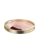 Vassoio rotondo L'Oca Nera con bordo effetto ottone spazzolato e fondo in vetro decorato con un motivo astratto nei toni del rosa, bordeaux e oro.