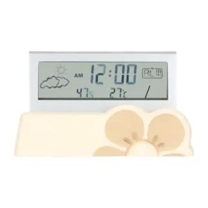Orologio digitale THUN Iconic Elegance con base in ceramica decorata con motivo floreale beige, display che mostra ora 12:00 AM, temperatura 27°C, umidità 47% e icone meteo sole e nuvole.
