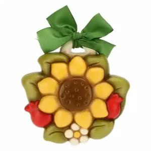 Formella THUN in ceramica a forma di girasole con fiocchetto verde, petali gialli e foglie verdi.